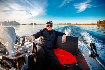 fisherman on a motor boat with spinning