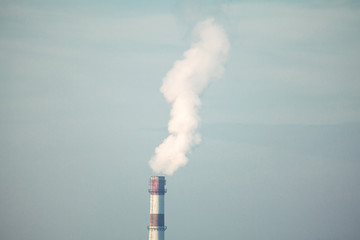 white chemical smoke from industrial pipe