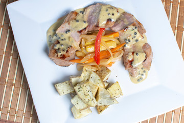 meat in passion fruit sauce, steamed potatoes and salad