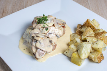 meat in mushroom sauce and french fries