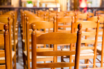 Wooden chairs in hall of old church, Europe