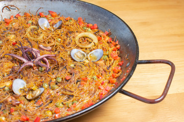  Traditional Spanish paella with different meat, seafood and vegetable ingredients