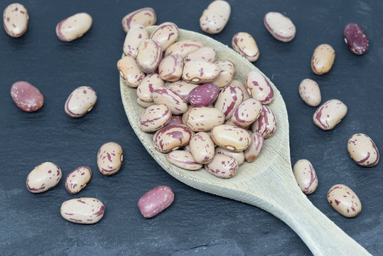 Bean pint or bean with wooden spoons on slate plate