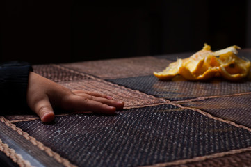 Obraz premium Orange on the table.Child holding a fruit