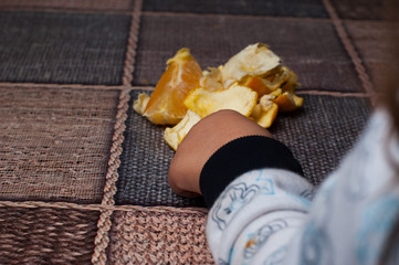 Orange on the table.Child  holding a fruit