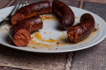 Roasted sausage in a plate on a table.Healthy food