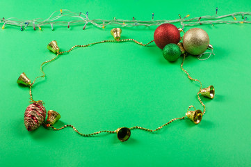Fototapeta premium Christmas decoration on the green background. Ornaments, snowflakes, stars. Copy space.