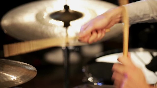 Drummer playing cymbal while performing at concert
