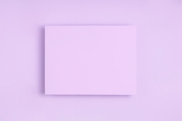 Minimal frame geometric composition mock up. Blank sheet of lilac paper postcard on delicate blue background. Template design invitation card. Top view, flat lay, copy space. Horizontal orientation.