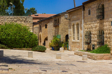 Fototapeta premium Israeli ancient city Jerusalem holy land street paved path way and stone living building in clear weather day time 