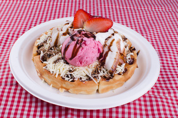 waffles with ice cream, chopped fruit and sauces