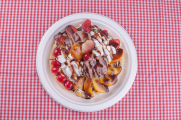 waffles with ice cream, chopped fruit and sauces