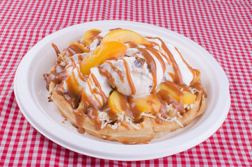 waffles with ice cream, chopped fruit and sauces