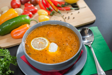 plate with solyanka with vegetables on the table