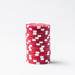 Stack of red poker chips on a white background