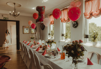 Baby girl 1 year old eating birthday cake in room. Birthday party. Childhood