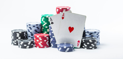 two aces and poker chips on a white background