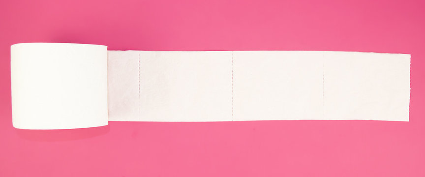white toilet paper roll on pink background