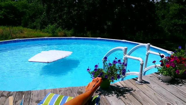 A summer backyard pool scene with a floating raft
