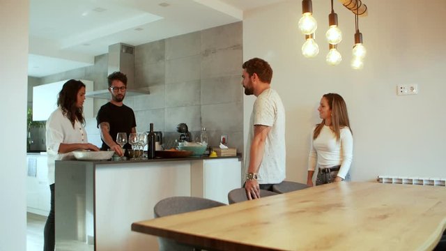 Focused Young Couple Preparing Glasses For Wine. Cheerful Young Friends Hanging Out Together. Hospitableness Concept