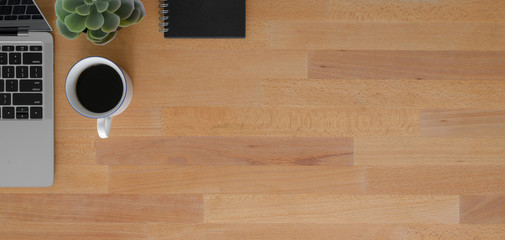 Overhead shot of comfortable workplace with copy space and office supplies on wooden table