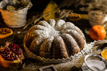 Italian traditional Christmas cake panettone torta pandoro powdered with vanilla and decorated with lace on wooden table