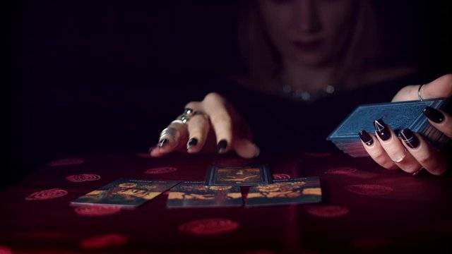 4k Mysterious Shot of Fortune Teller Placing on Table Tarot Cards