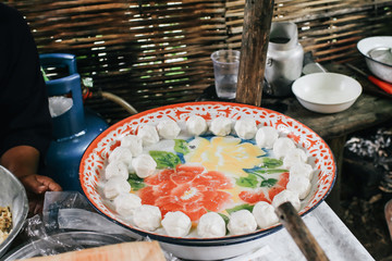 small rice balls in silver tray to make Swan Eggs Dessert, in Thai, Kanom Kai Hong. Workshop on a street market or Thai style sticky rice dumplings in sweet coconut milk dessert, preparation concept w
