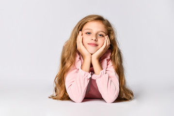 Portrait of a young woman lying on the floor isolated on white background