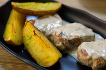 Prepared sirloin medallion with mushrooms sauce and potato