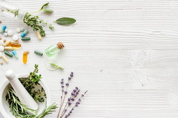 Apothecary of natural wellness and self-care. Herbs and medicine on white wooden background top...