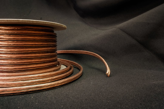 speaker wire coil on grey background