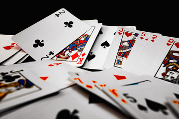 Pile of playing cards on black background