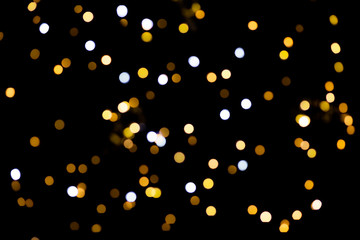 big yellow golden bokeh for background on black. Christmas lights.