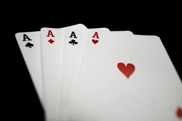 four aces on black background