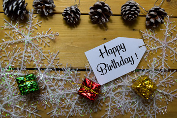 Happy Birthday write on label with wooden backgroud. Frame of Christmas Decoration.