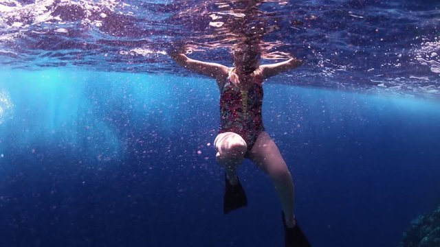 Woman Swimming In Tropical Blue Sea Beside Coral Reef