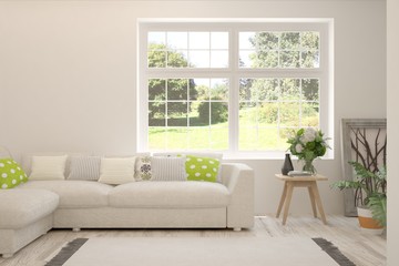Stylish room in white color with sofa and summer landscape in window. Scandinavian interior design. 3D illustration