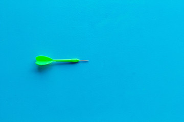 Plastic dart or arrows for darts game on blue background top view copy space