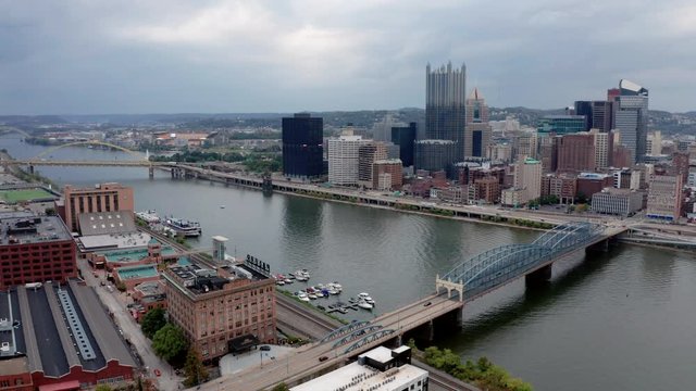 Clouds roll by while people move over the river into and out of Pittsburgh PA