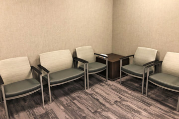 Modern interior of a clinic reception room with chairs for sitting. Professional business office waiting area.