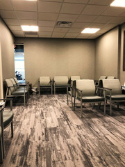 Professional business office waiting area. Modern interior of a clinic reception room with chairs for sitting.
