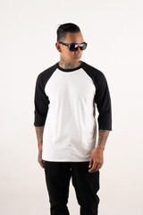 Young man posing wearing black white raglan t shirt 3/4 sleeve isolated on background