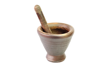 Baked clay mortar with a wooden pestle isolated on white background