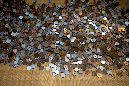 stack of asian money coints on bamboo mat