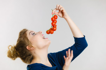 Woman holding fresh cherry tomatoes