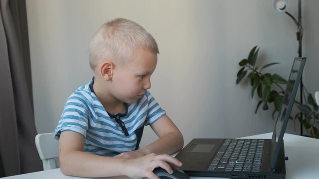 Boy working on a computer, programming, learning or playing