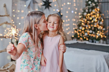 Obraz premium girls admire the sparklers at the celebration