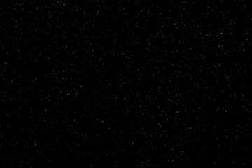 WHITE BOKEH ON A BLACK BACKGROUND. LIGHT SPOTS TEXTURE. FALLING SNOW. STAR SKY.