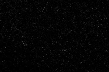 WHITE BOKEH ON A BLACK BACKGROUND. LIGHT SPOTS TEXTURE. FALLING SNOW. STAR SKY.
